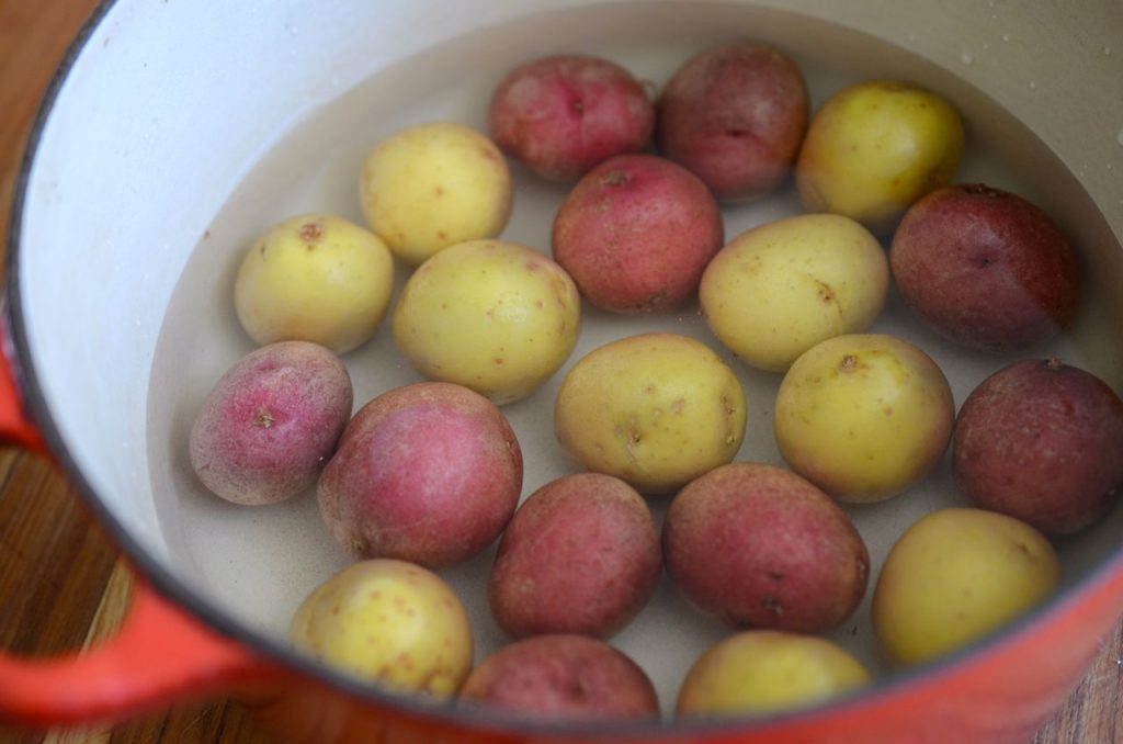 baby potatoes in pot with water