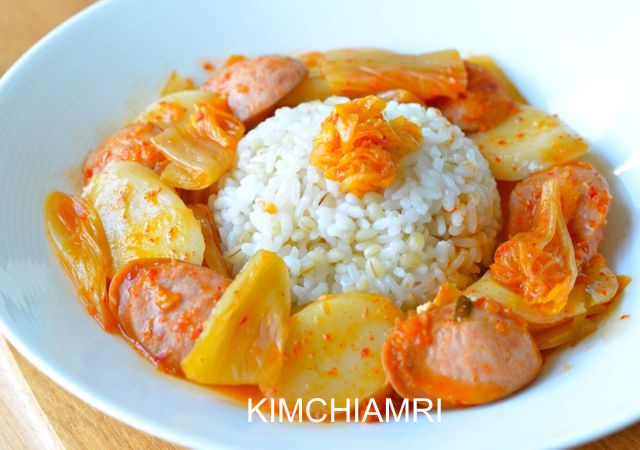 Budae Jjigae served with Round rice mound in the middle of bowl