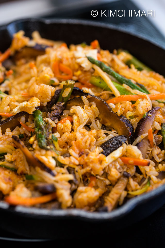 Close up of bibimbap all mixed with vegetables, beef and gochujang sauce