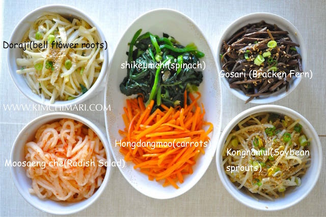 Bibimap vegetables in bowls - spinach, carrots, soybean sprouts, radish, bracken fern, bellflower roots