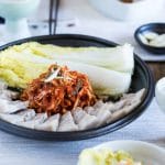 Table setting of a plate of bossam with makgeolli