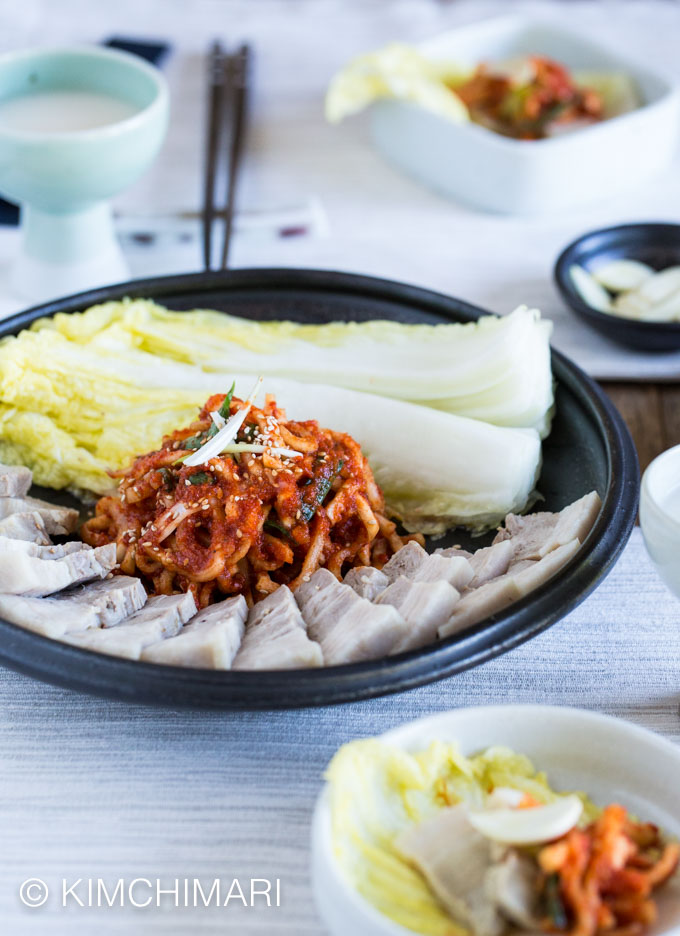 Table setting of a plate of bossam with makgeolli