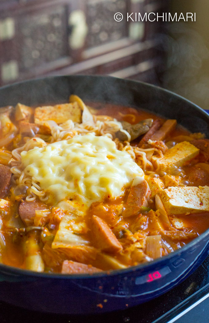 Side view of Budae Jjigae cooked in pot with steam escaping