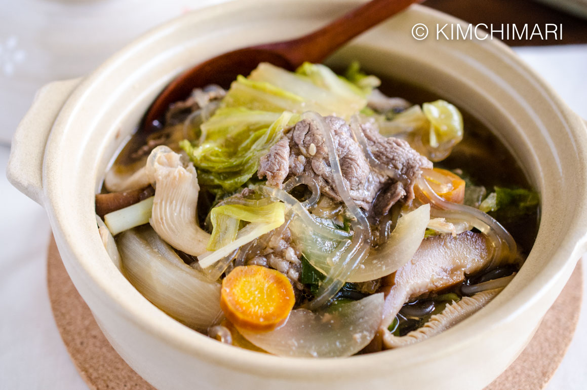 Bulgogi Hot Pot (Jeongol) served in white clay pot with wooden spoon