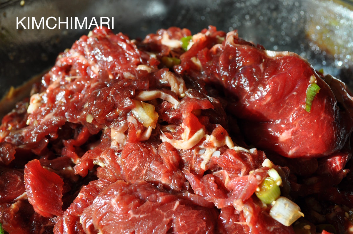 Raw beef sirloin marinated inside glass bowl