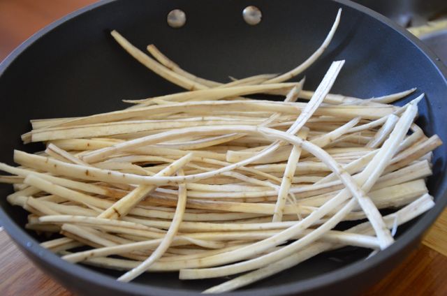 Burdock sticks in frying pan 