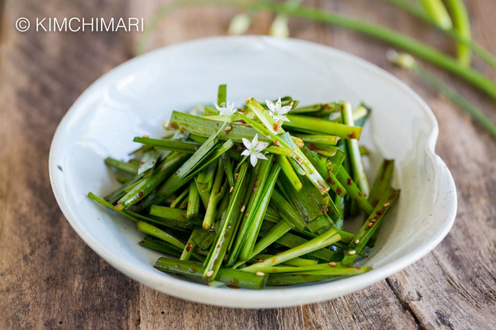 Chive Salad with chive flowers in grey bowl