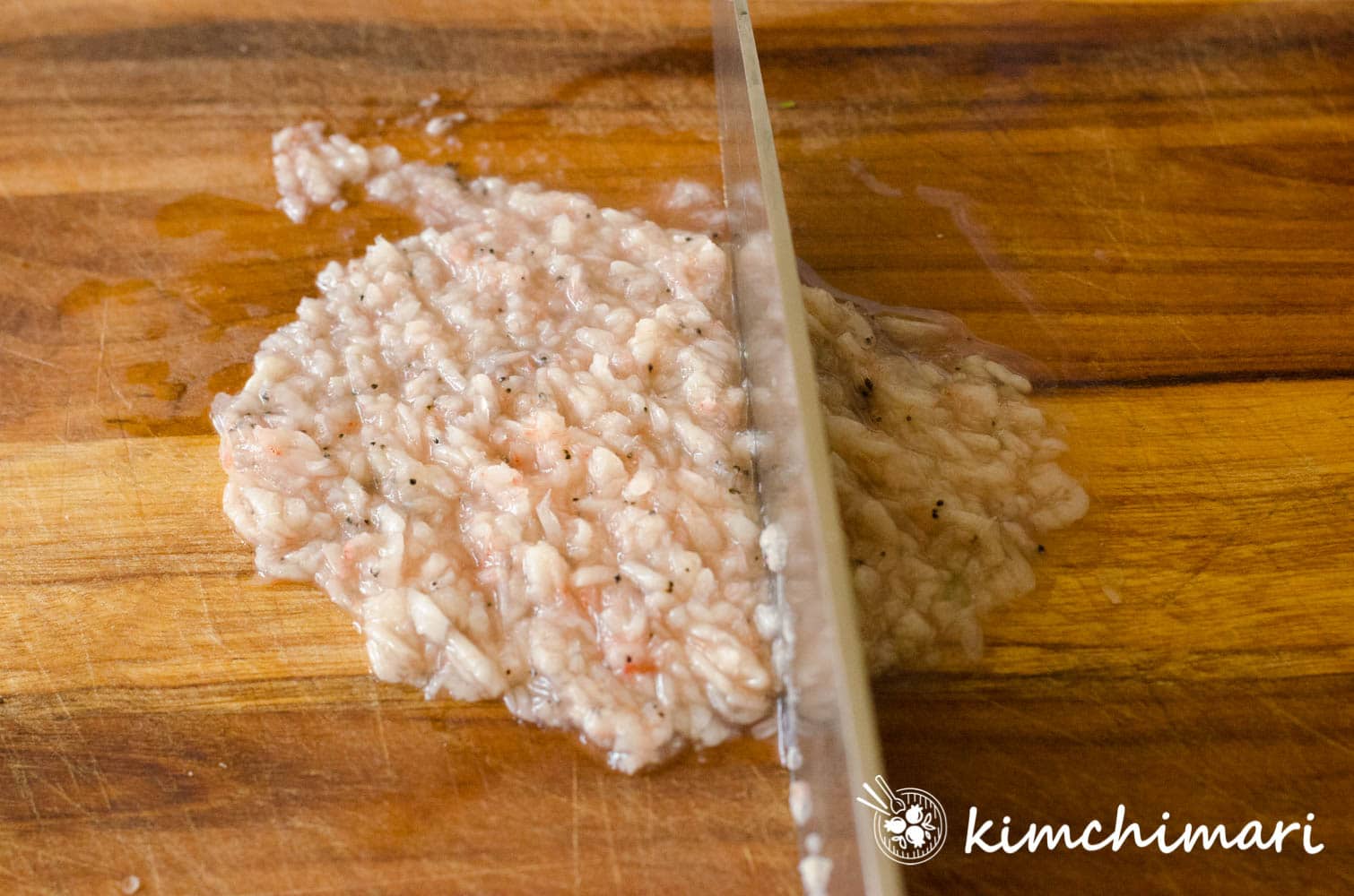 saewoojeot being chopped on wooden cutting board