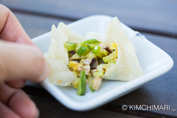 dumpling is torn open to show the vegetable stuffing inside