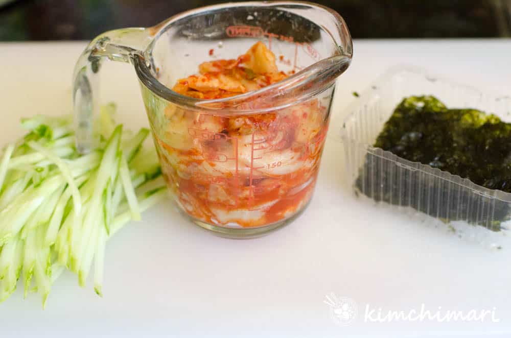 julienned cucumber, kimchi and roasted gim on white board