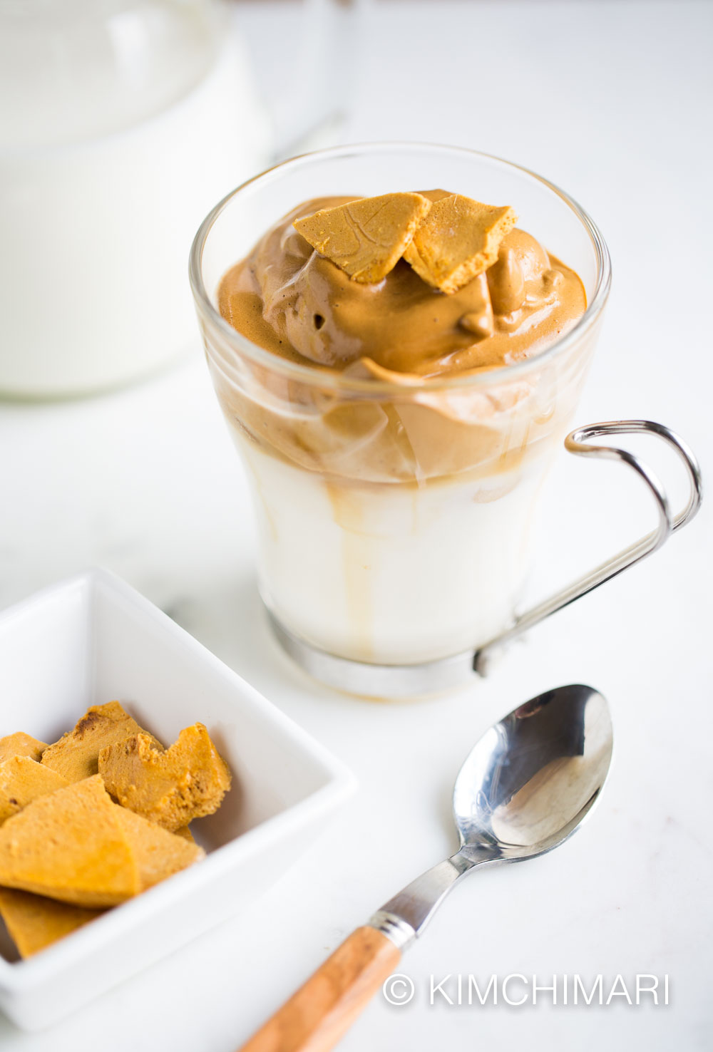 Dalgona Coffee served in glass cup with a spoon