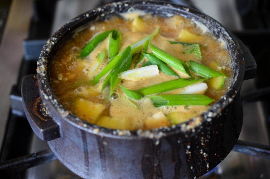 Doenjang Jjigae finished with green onions added