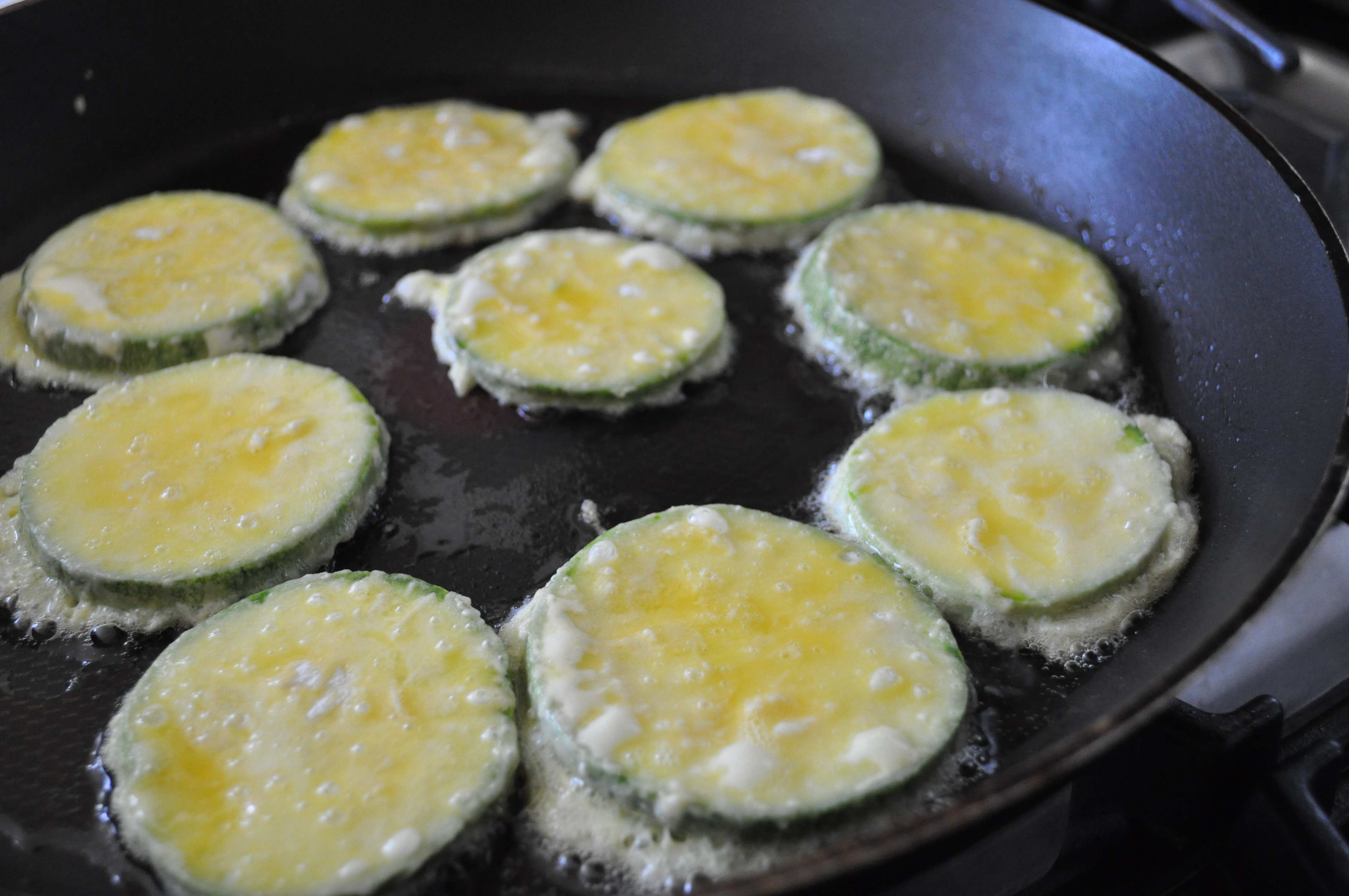 The jeon pieces cooking in the pan