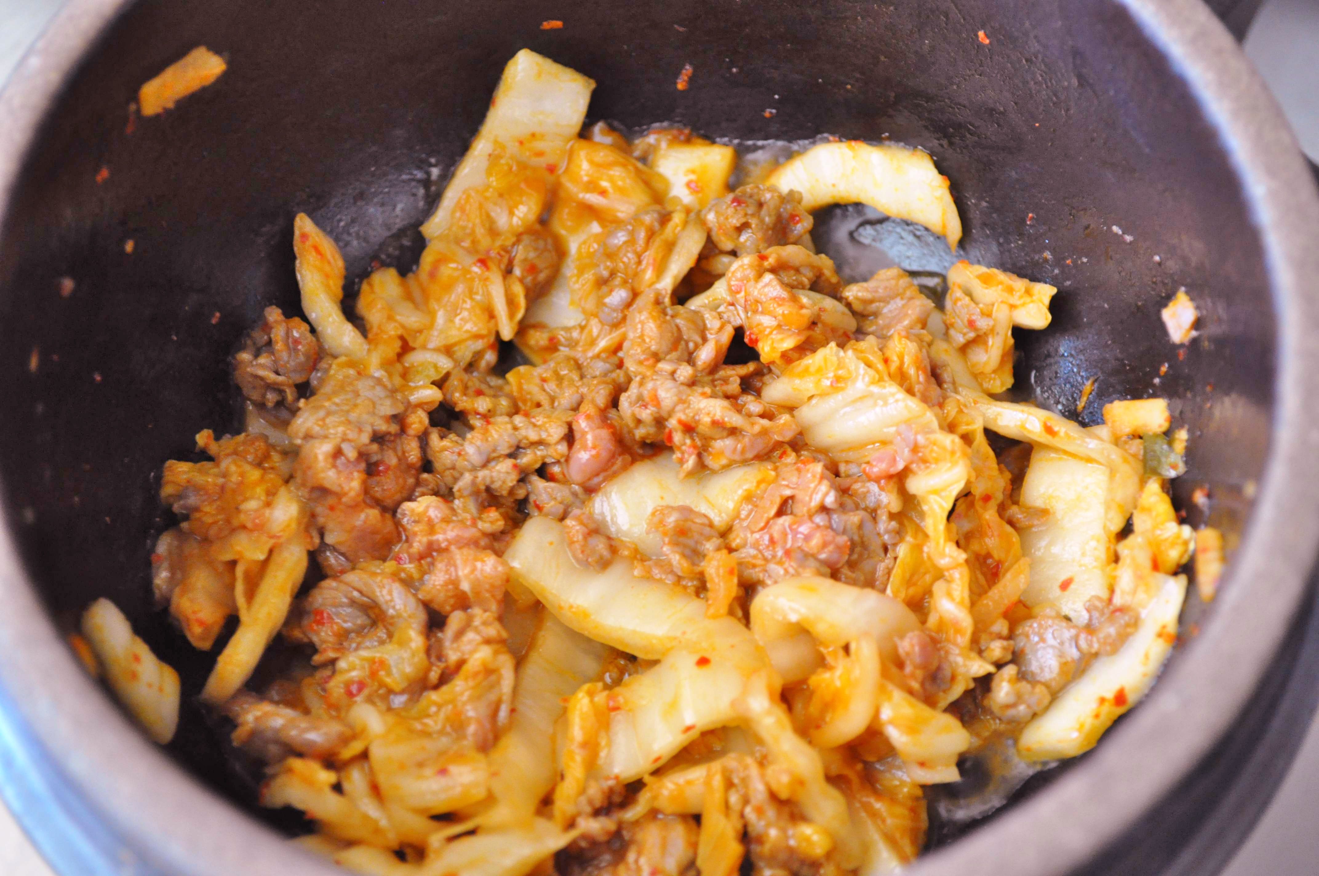 kimchi and beef cooking in hot pot