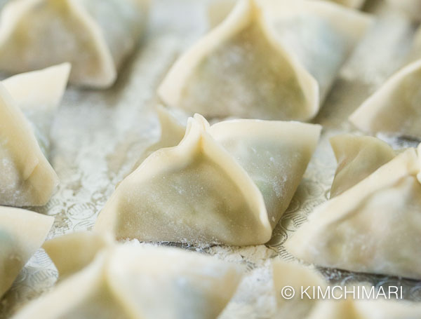 closeup of finished vegetarian dumplings in metal tray