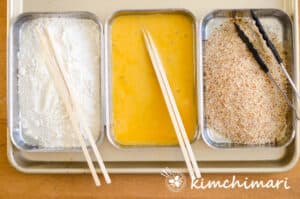 flour egg wash and bread crumbs in bowls for chicken katsu