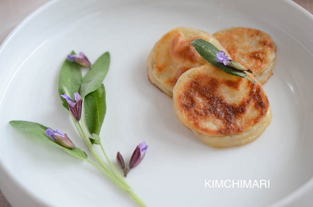 Gamjajeon styled with sage flowers and leaves