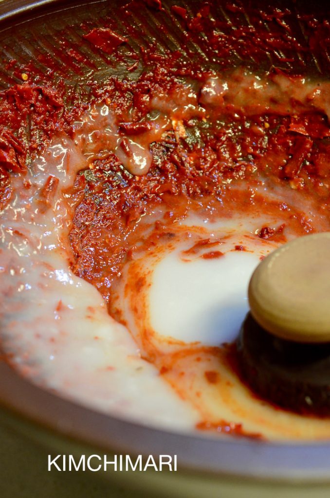 Mixing sweet rice paste with red chili pepper for Kimchi