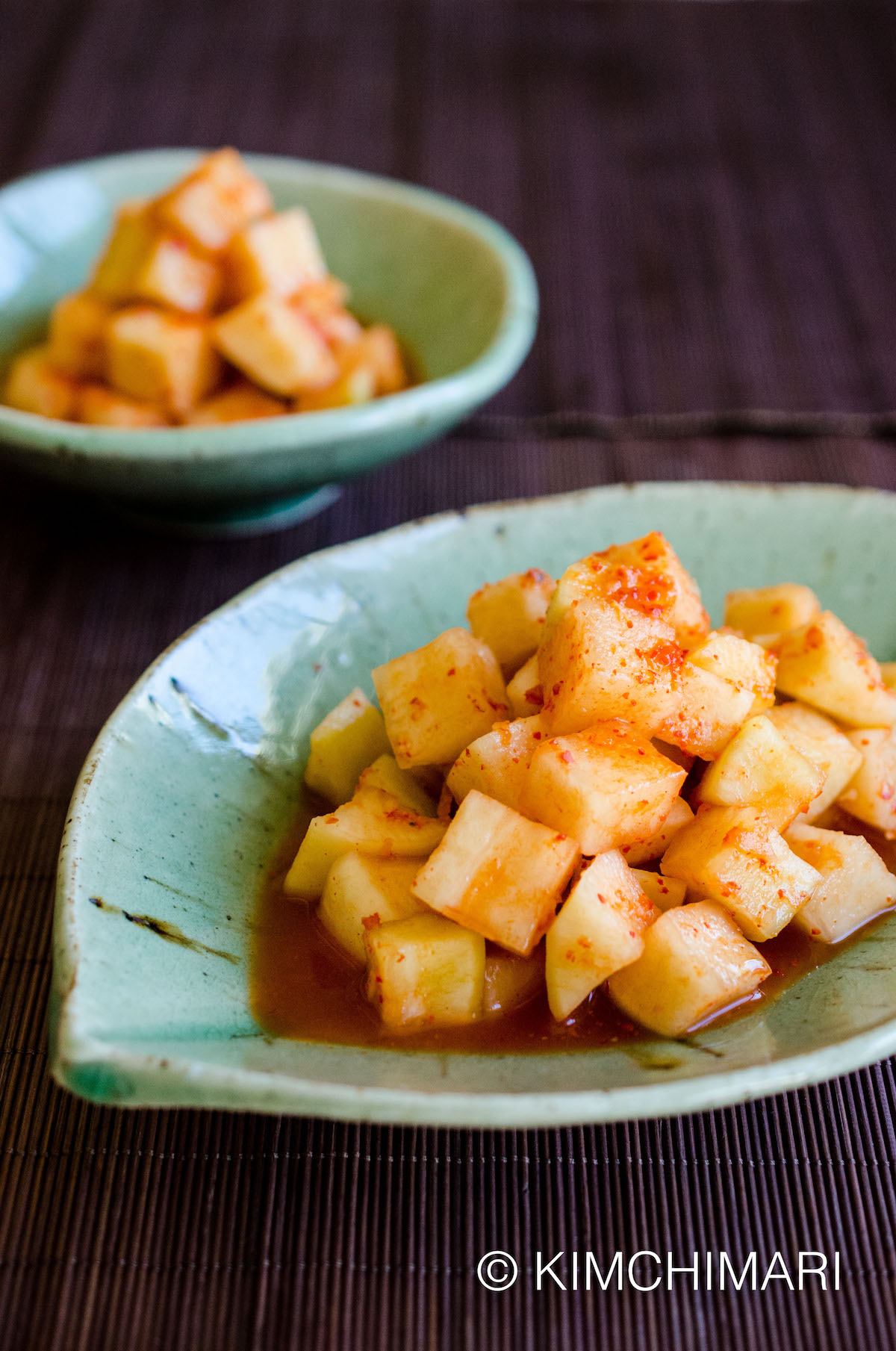 Kkakdugi Cubed Radish Kimchi plated in green leaf shaped dish