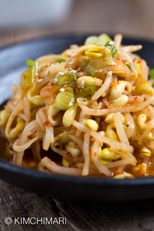 Kongnamul Muchim (Spicy Soybean Sprouts) closeup plated on black plate