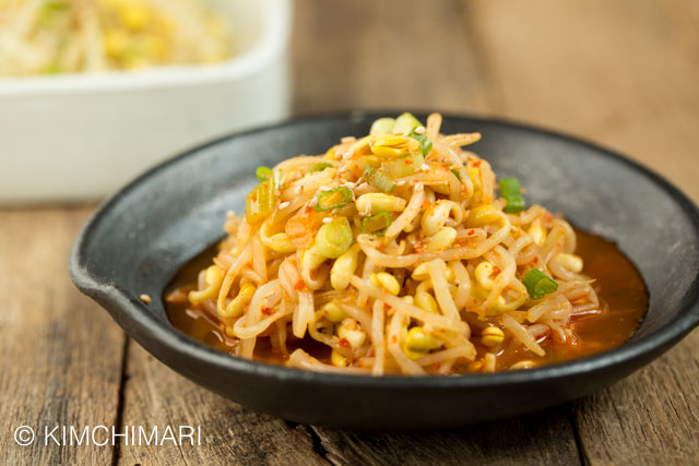 Soybean sprouts (Kongnamul Muchim) on black dish on wooden table