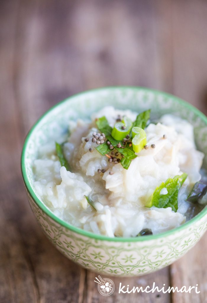 Dakjuk (chicken rice porridge) served in small bowl topped with perilla seeds