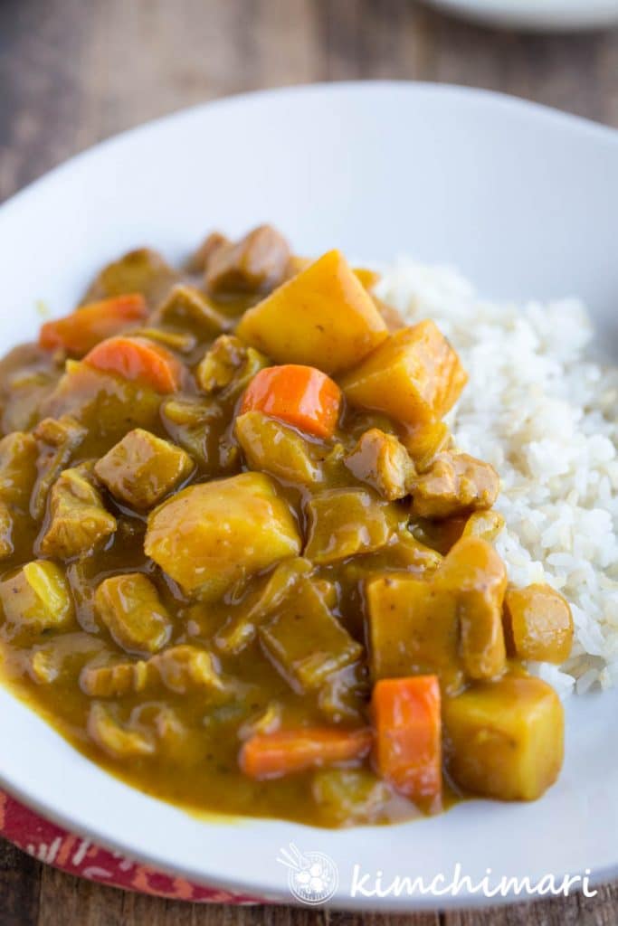 Korean Curry Rice plated on a bed of rice on white plate