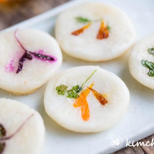 cooked flower pancakes of yellow, purple flowers on white dish