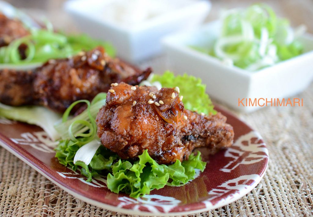 Korean Fried Chicken plated with lettuce and green onions