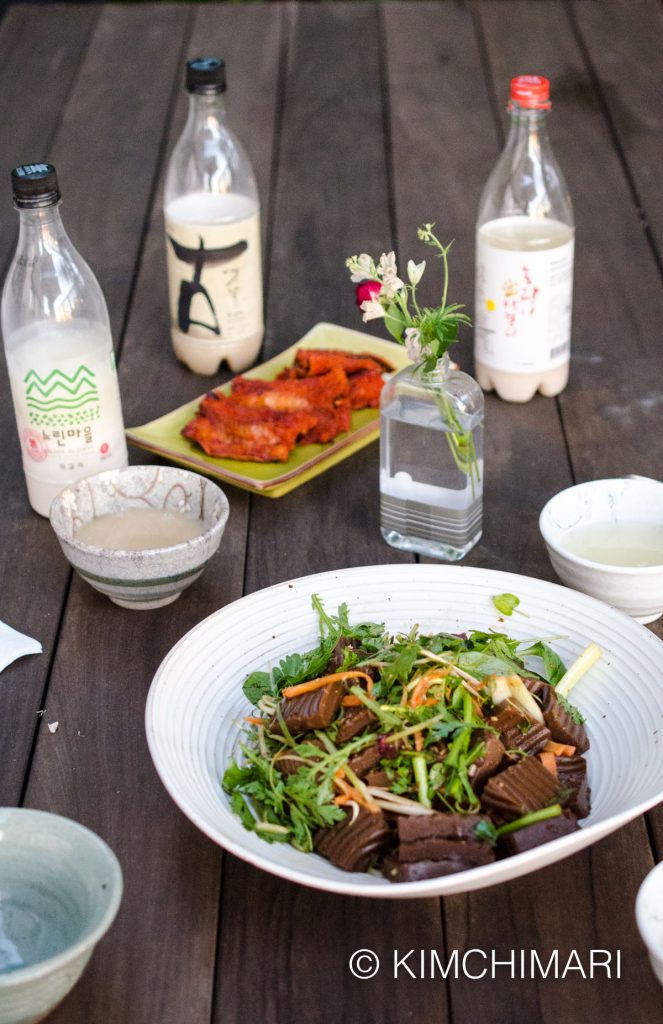 table setting of Makgeolli with Muk Muchim with bowls