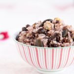 mulgrain rice in pink striped bowl on white background