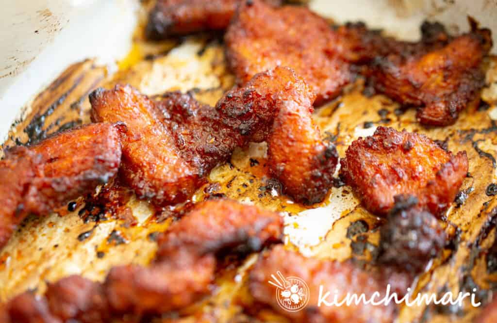 close up of oven baked pork on parchment paper