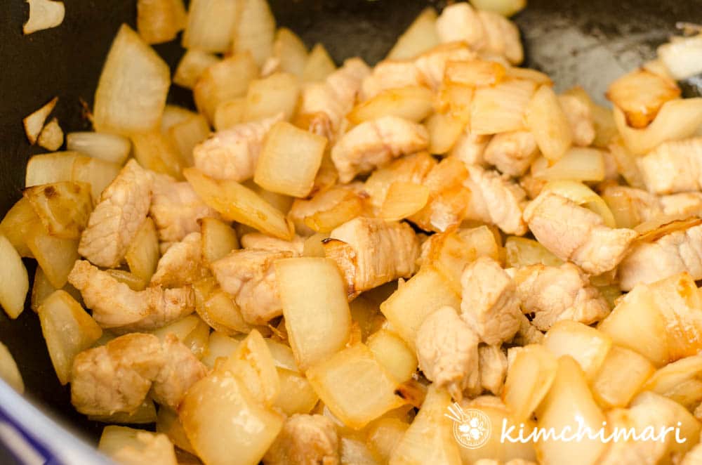 pork and onions fully sauteed in pan