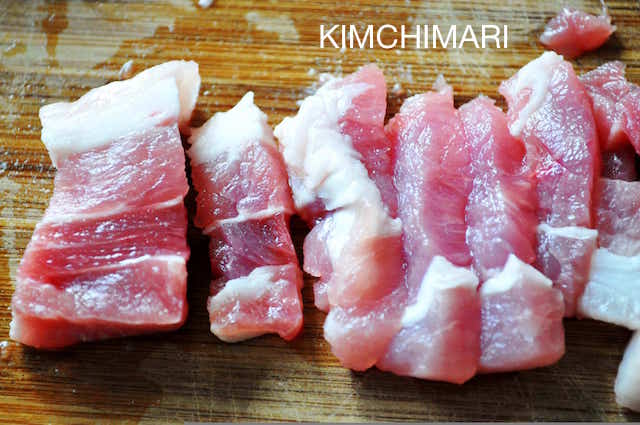 slices of pork belly on cutting board