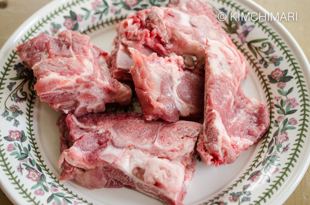 Raw Pork Neck Bones arranged on plate