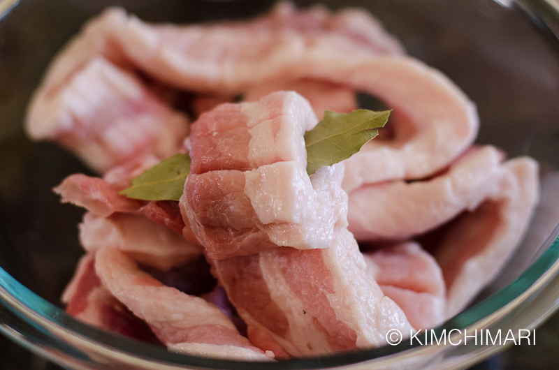 half rolled up pork belly slice with bay leaf in the middle