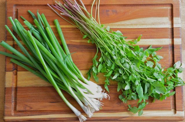 cleaned minari and green onions on cutting board