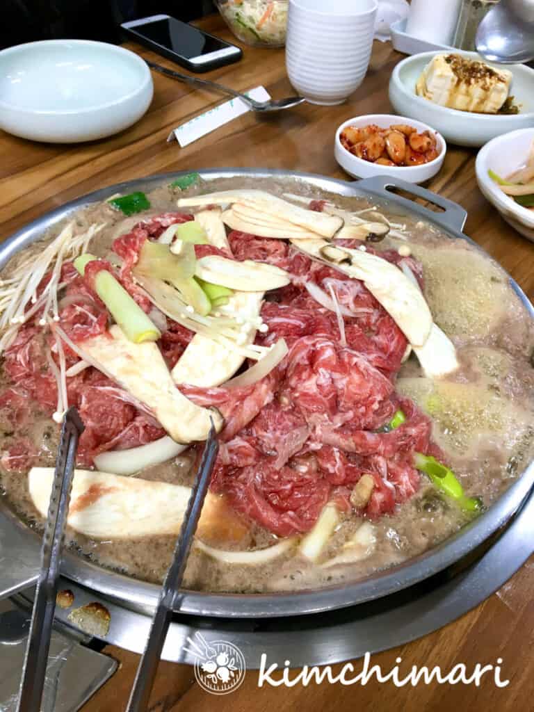 seoul bulgogi style cooking in bulgogi dome pan at table