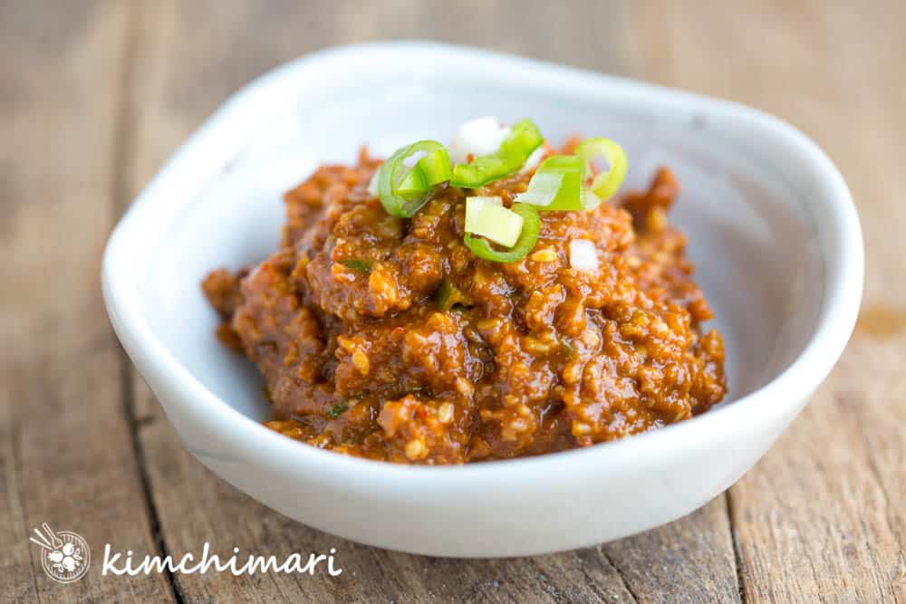 ssamjang in a bowl topped with green onions