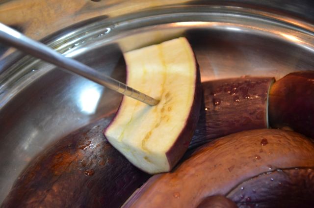 checking steamed eggplant to see if it's cooked