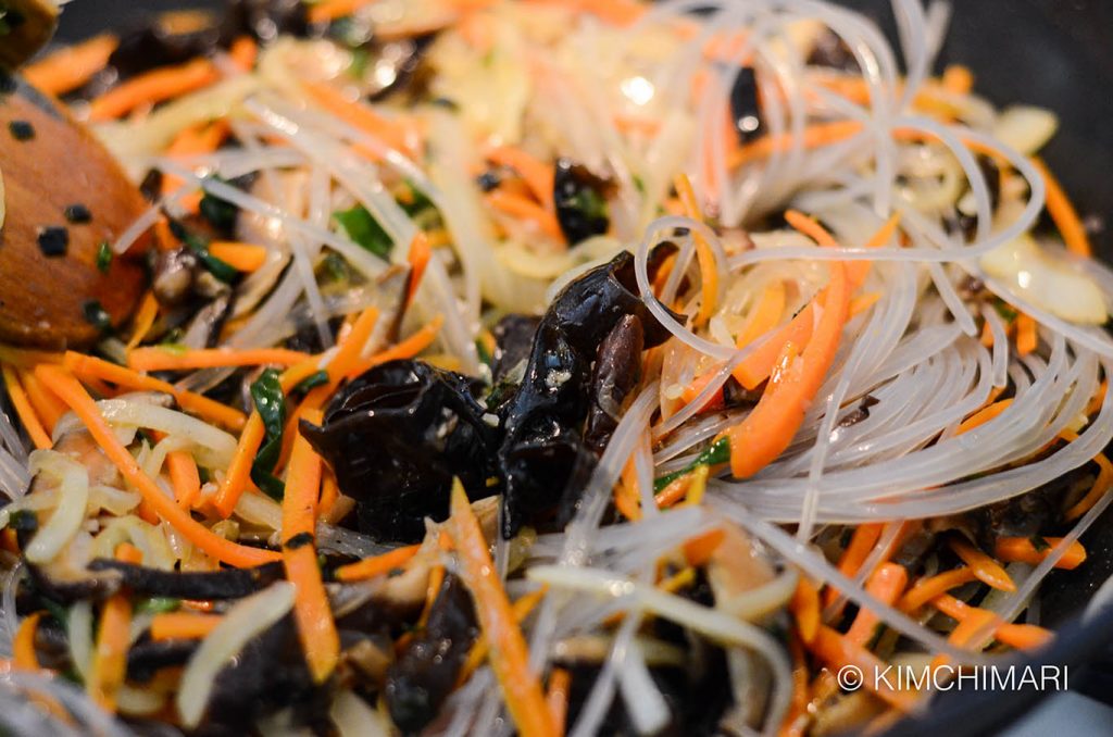 Stir-frying veggies and Japchae noodles