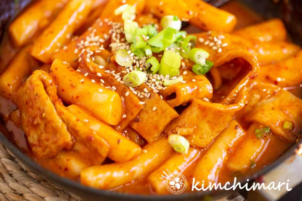 tteokbokki finished with green onions and sesame seeds
