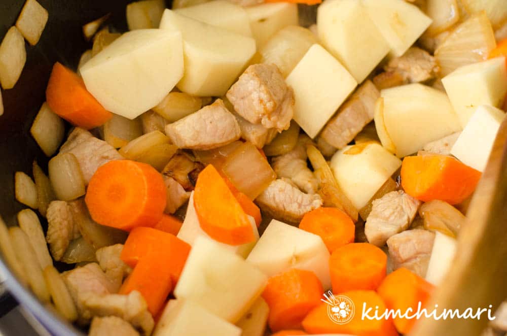 vegetables added to pot to saute with pork and onions