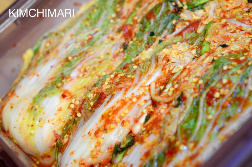 whole cabbage Kimchi with pepper seeds in container