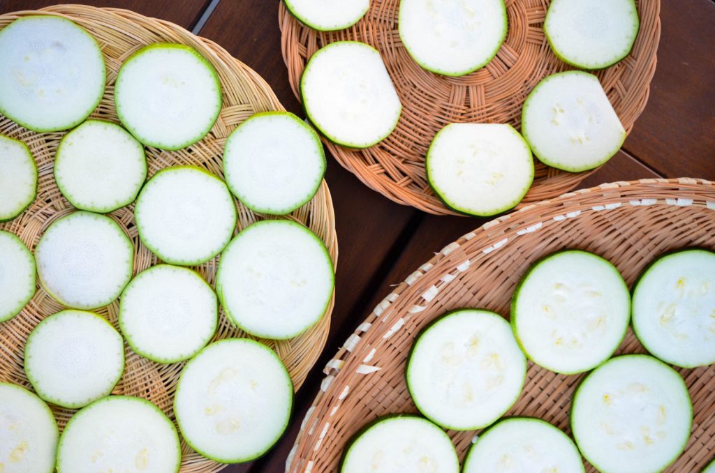 Zucchini slices laid out for drying in sun